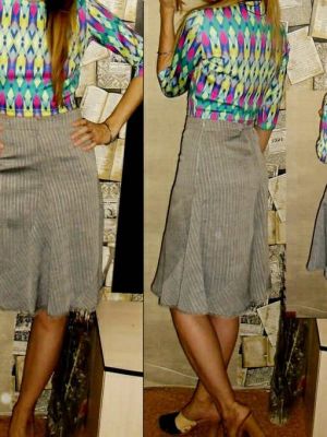 Trendy spiral midi-nederdel i denim, fusionerer klassisk stil med unikt twist for et casual-chic look.